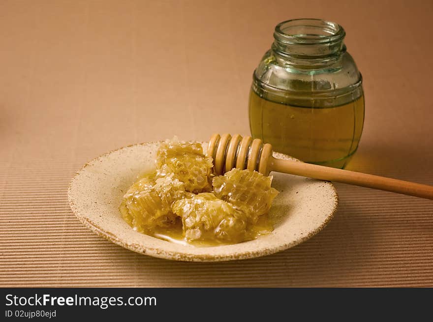 Honeycombs and wooden honey stick