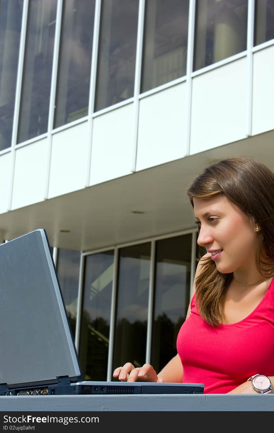 Woman working with a laptop, sitting. Woman working with a laptop, sitting