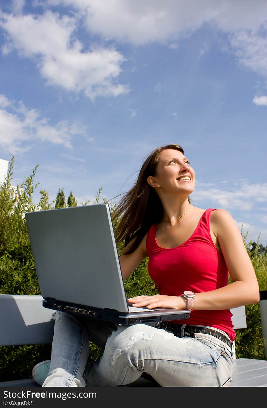 Woman working with a laptop, sitting. Woman working with a laptop, sitting