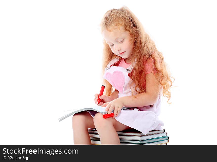 Portrait of a little girl sitting on a stack of books. Isolated over white background. Portrait of a little girl sitting on a stack of books. Isolated over white background.