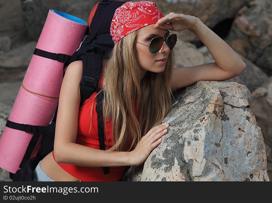 Young woman tourist posing at the mountains. Young woman tourist posing at the mountains.