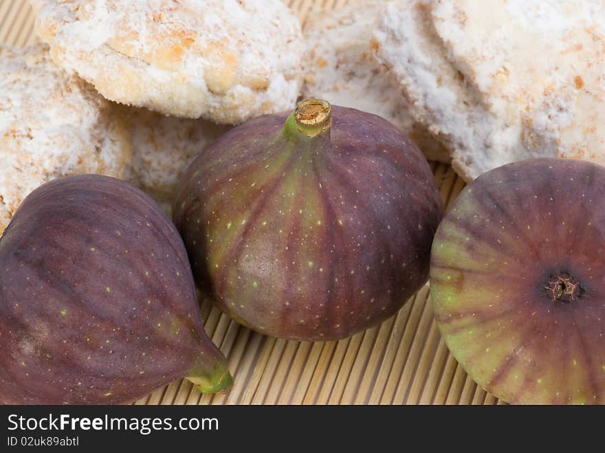 Still life with cookies and figs on bamboo table