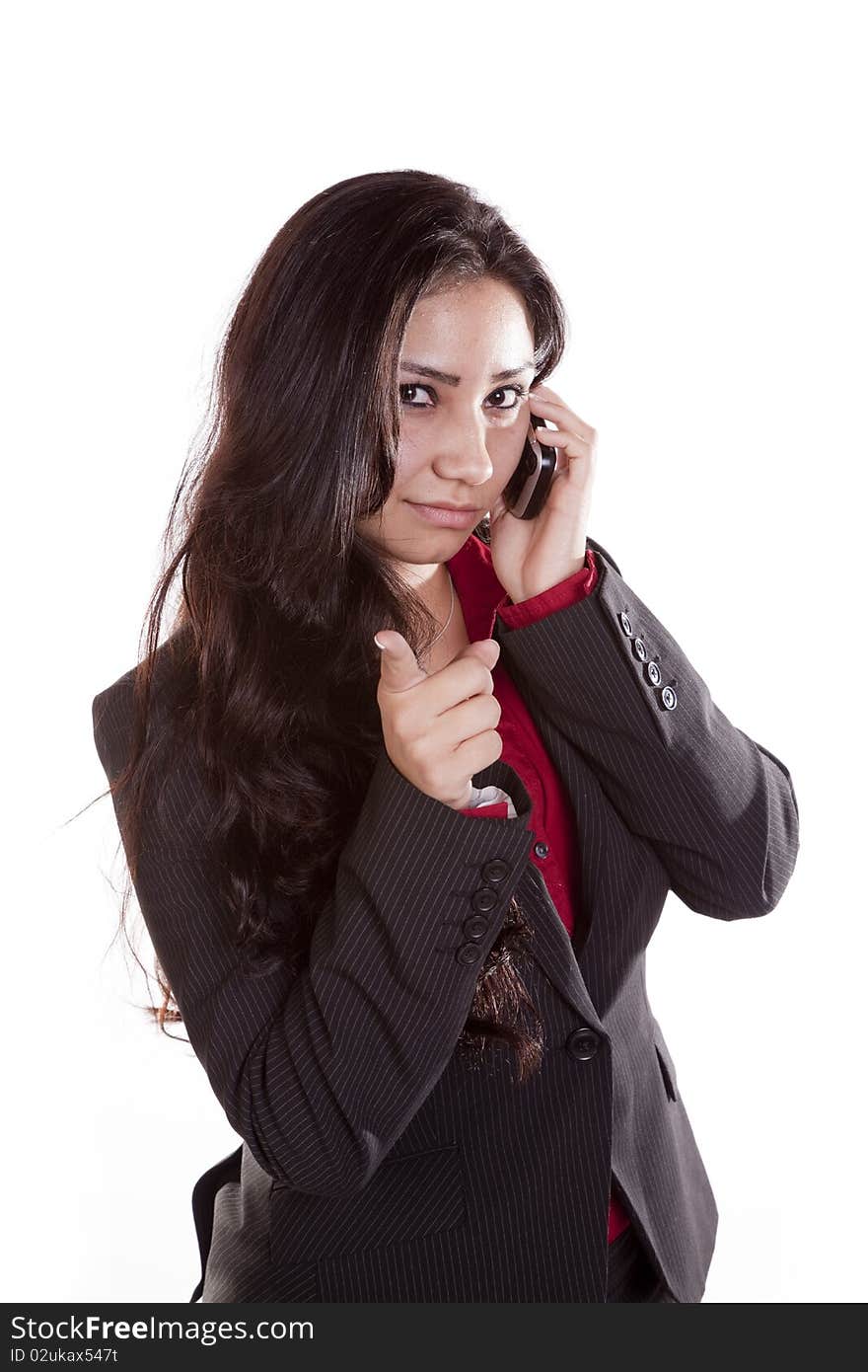 A woman is on her cell phone and pointing her finger. A woman is on her cell phone and pointing her finger.