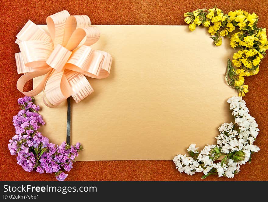 Greeting card with bow and flowers. Studio shot