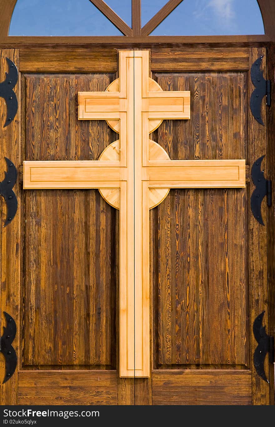 Cross from a tree, being on a door in a temple. Cross from a tree, being on a door in a temple