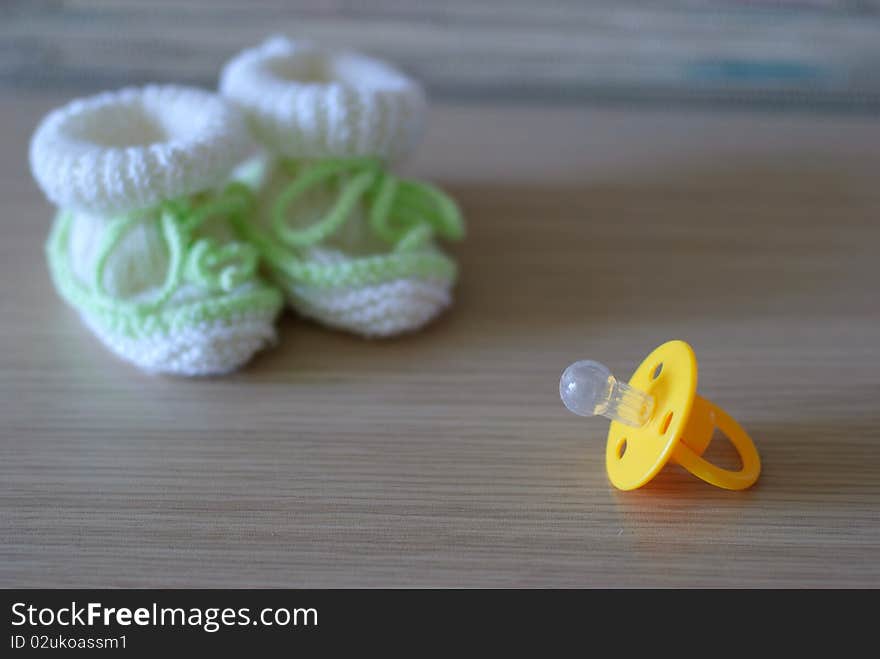 Baby s bootees and pacifier