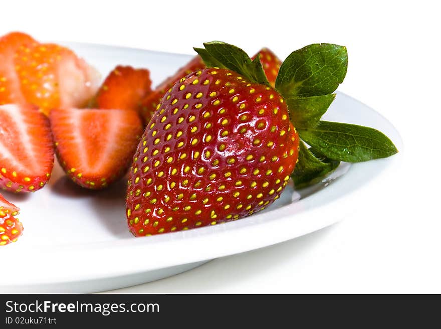 Fresh strawberries on a dish. Chopped and whole