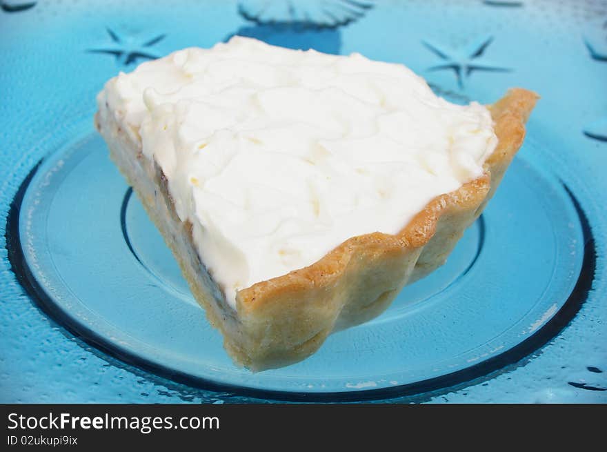 Banana cream custard pie on blue glass plate. Banana cream custard pie on blue glass plate