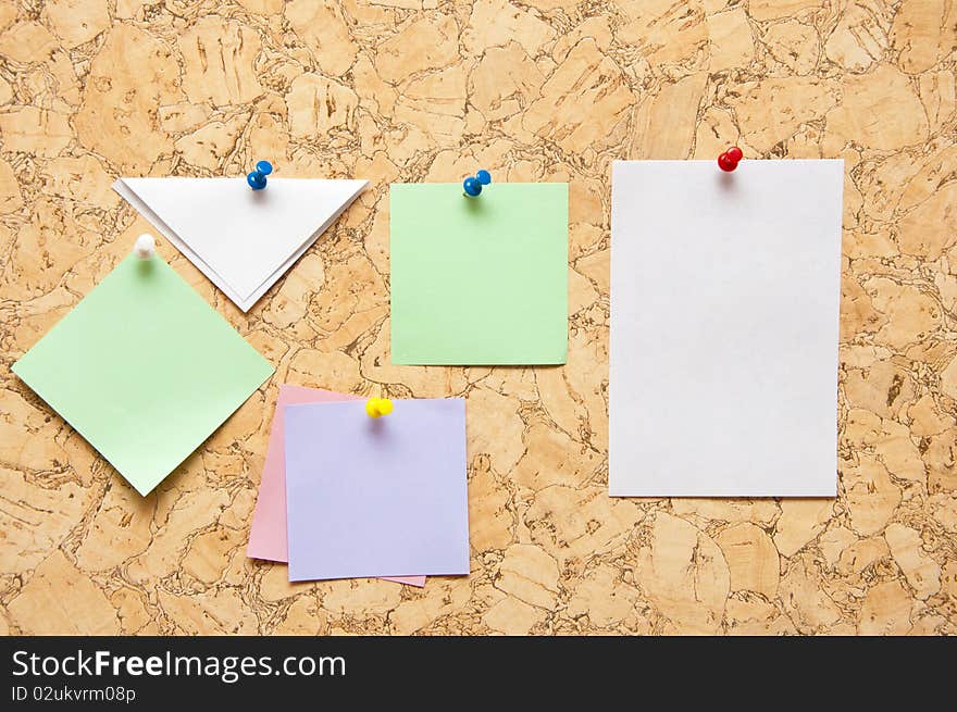 Color sticky notes over brown cork background