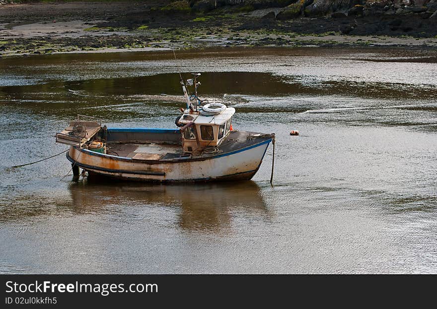 A small fishing boat in the harbour at Milford Haven, Wales.