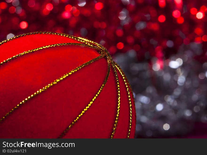 Ed christmas tree decoration with golden stripes with light blurs in the background. Ed christmas tree decoration with golden stripes with light blurs in the background