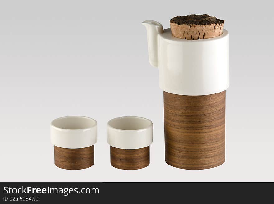 A tea set consisting of a kettle and 2 cups with a unique design