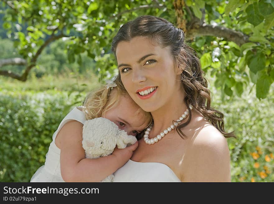 Bride and Young Bridesmaid enjoying a moment together in the garden prior to the wedding