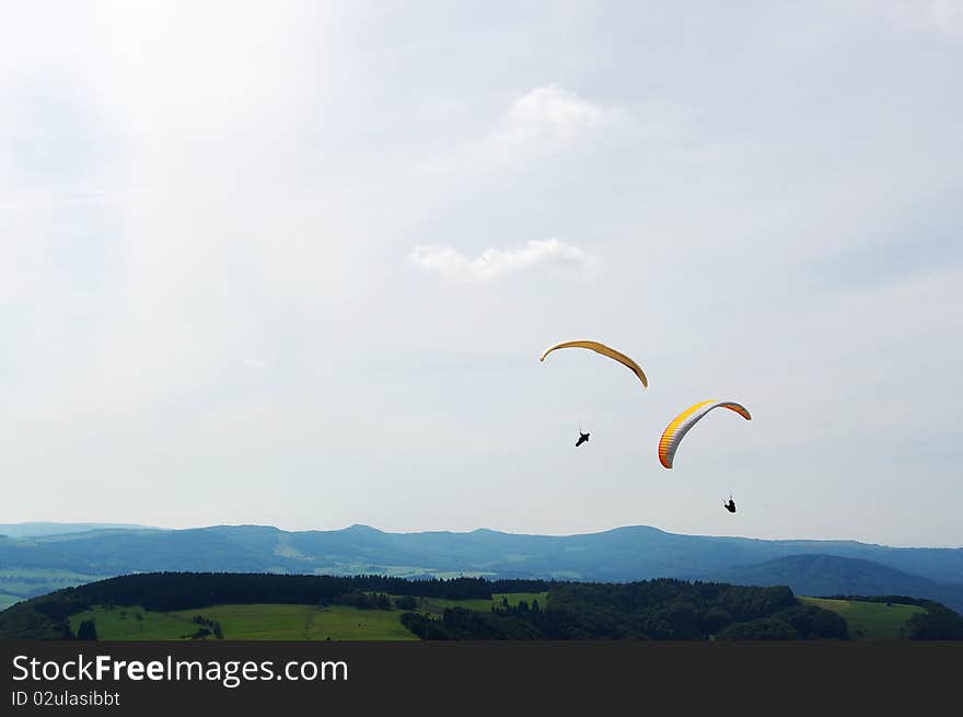 Fun sports: Two colorful paraglider up in the air. Fun sports: Two colorful paraglider up in the air.