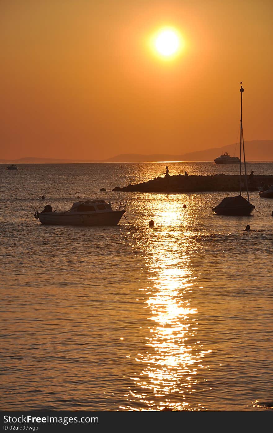 Beautiful sunset and the ships that anchored in the harbor