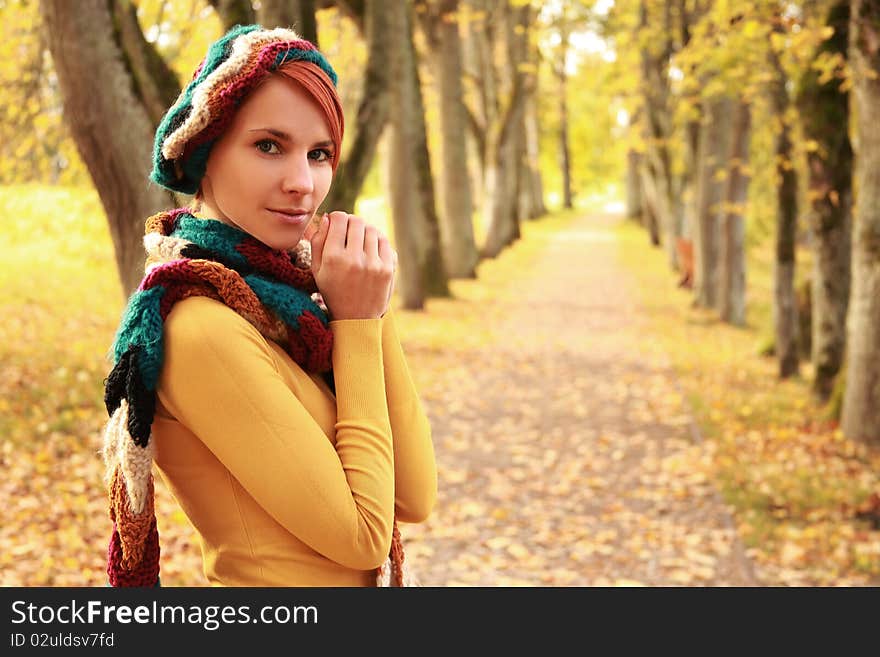 Young girl walking in autumn park. Young girl walking in autumn park