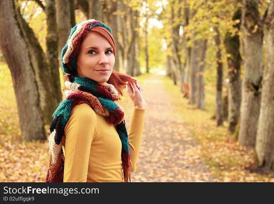 Young girl walking in autumn park. Young girl walking in autumn park