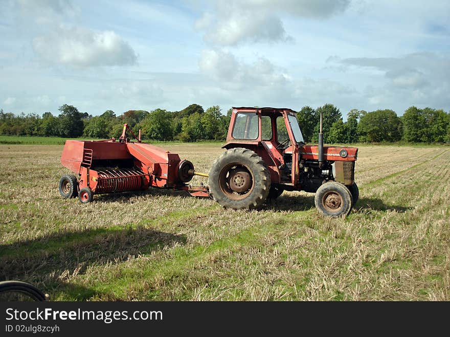 A vintage tractor and bale equipment at an agricultural show