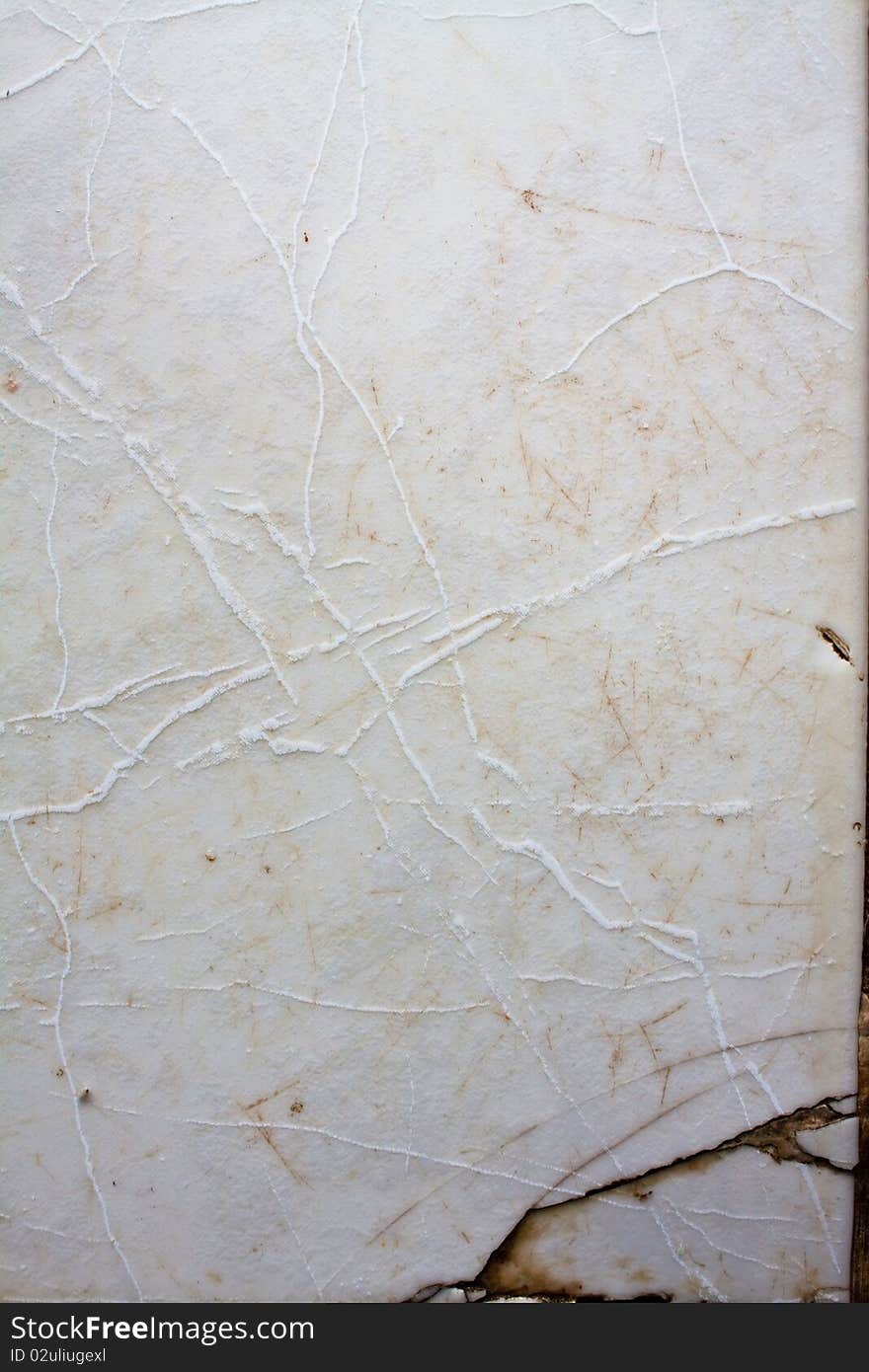 Detail of a white cracked marble surface. Detail of a white cracked marble surface