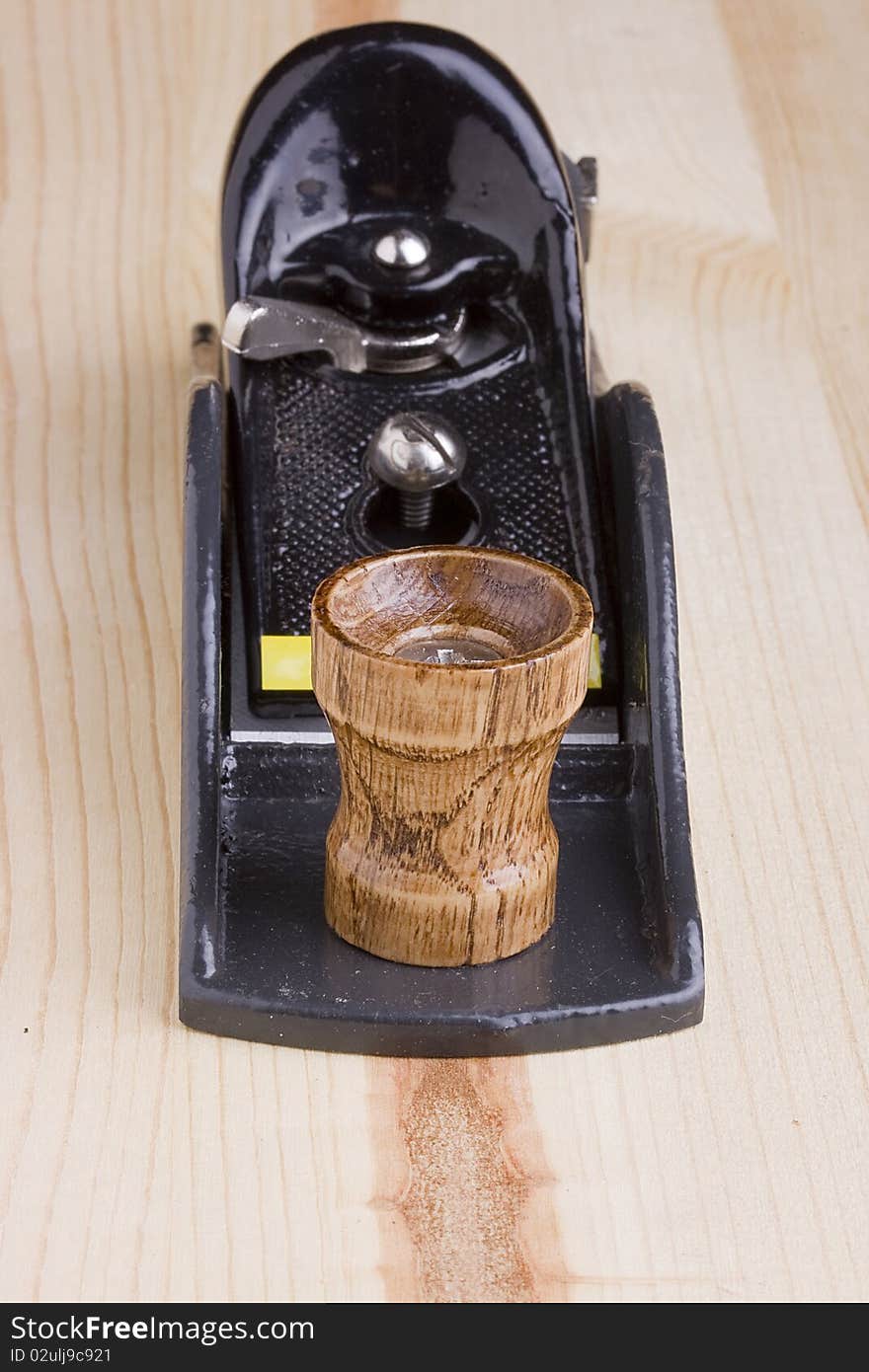 Woodworking handplane on a piece of wood.