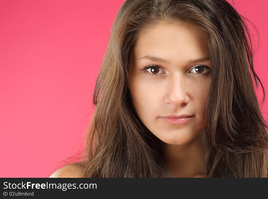 Young beautiful woman with long hair posing on vivid background. Young beautiful woman with long hair posing on vivid background