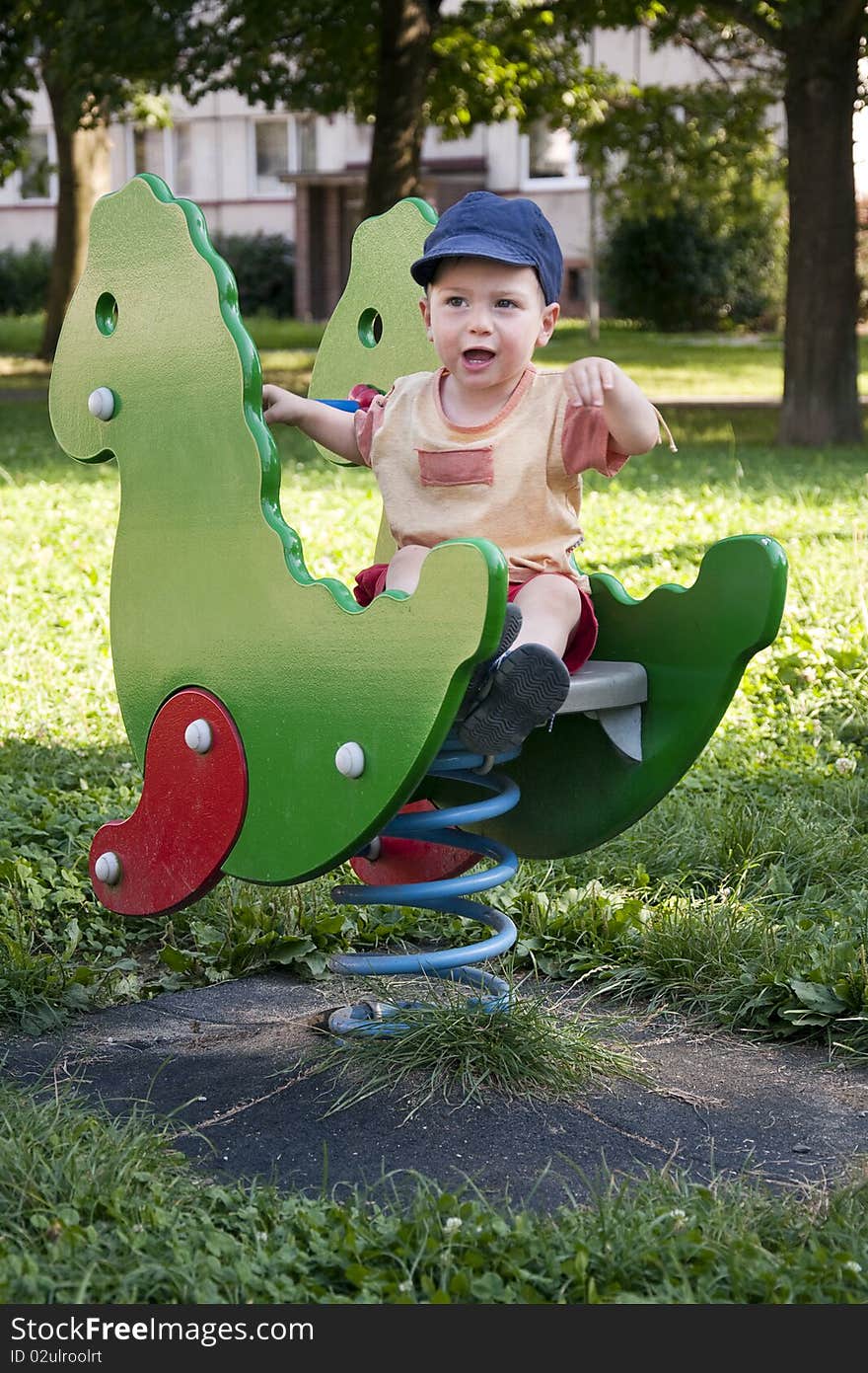 Portrait of a small child boy on the outdoor playground toy. Portrait of a small child boy on the outdoor playground toy.