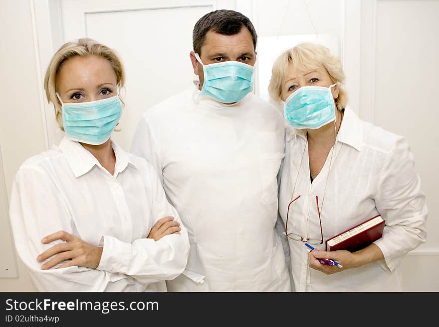 Three doctors  in uniform.Front view. Three doctors  in uniform.Front view