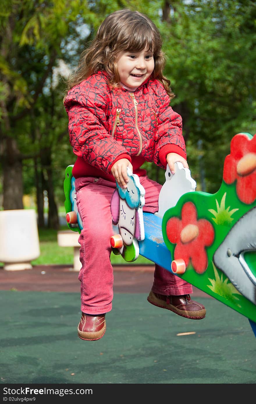 Little girl plays in playground