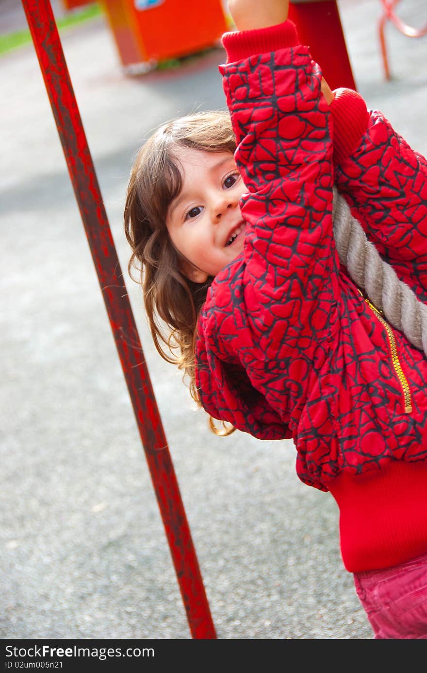 Little girl plays in playground