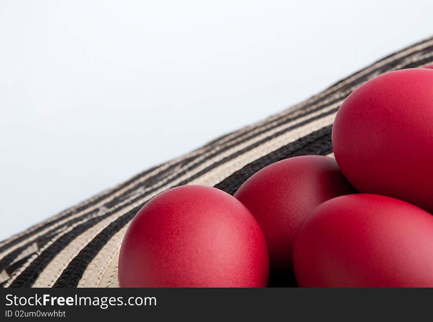 Many red Easter eggs on a specific Easter fabric.