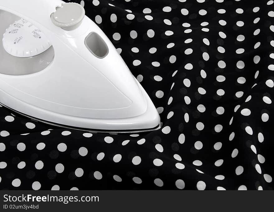 Ironing delicate black and white polka fabric. Ironing delicate black and white polka fabric.