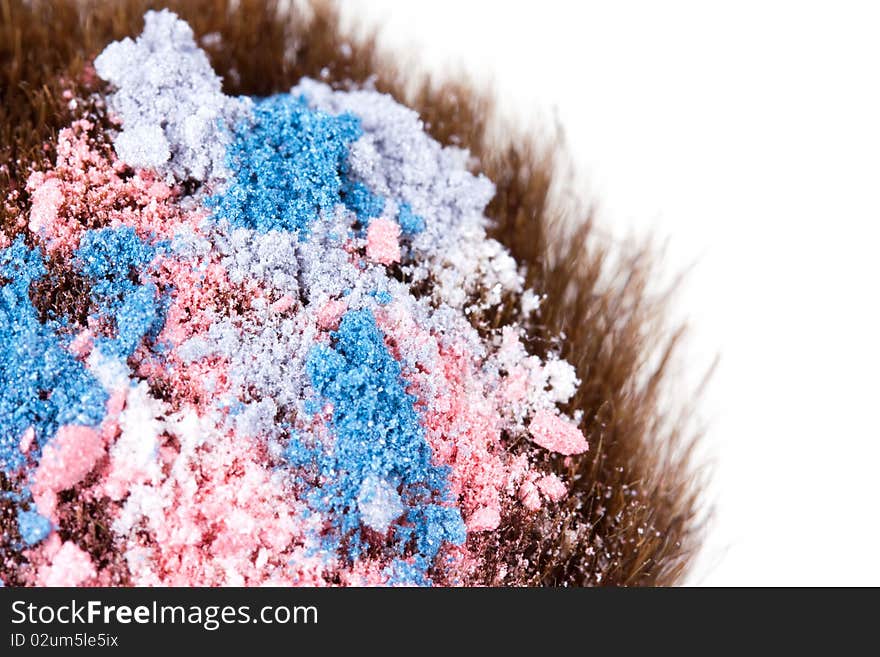 Eyeshadows on professional make-up brush, macro on white