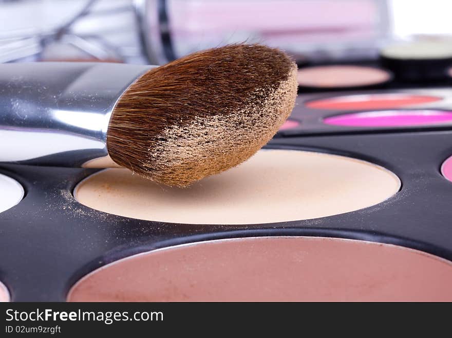 Professional make-up brush on eyeshadows palette, closed-up