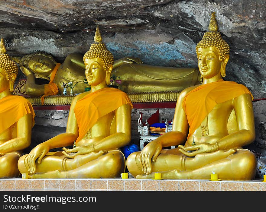 Gold Buddha in the cave and stone background of temple Thailand. Gold Buddha in the cave and stone background of temple Thailand