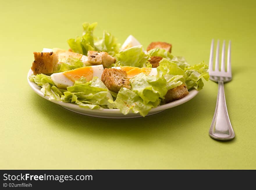 Salad with eggs on green background. Salad with eggs on green background