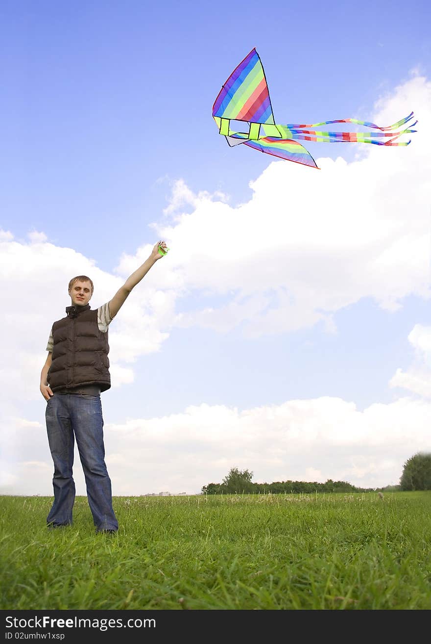 Man standing and playing with kite