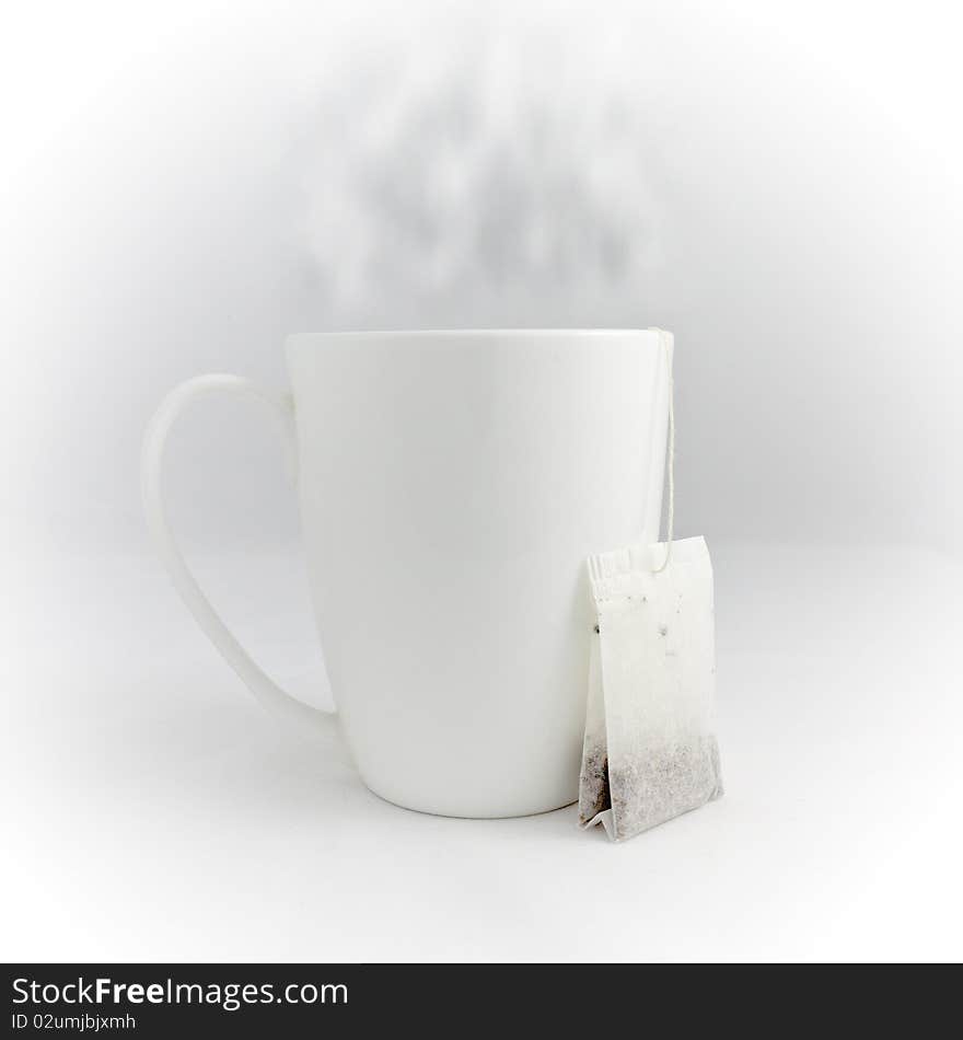 Tea cup with tea on white background. Tea is outside of the cup. Tea cup with tea on white background. Tea is outside of the cup.