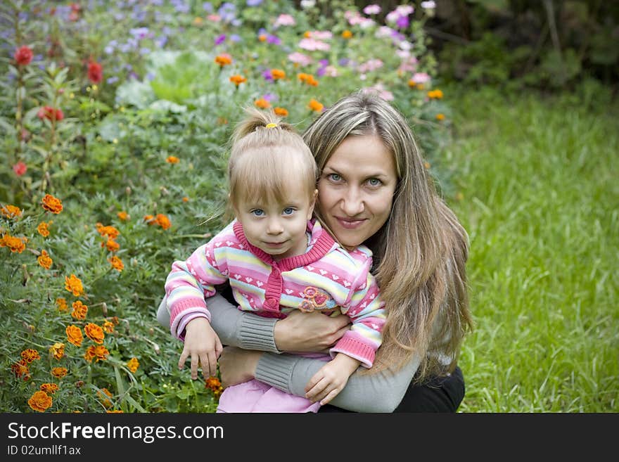 Girl with her mother in the garden