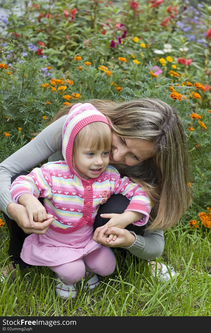 Girl with her mother in the garden