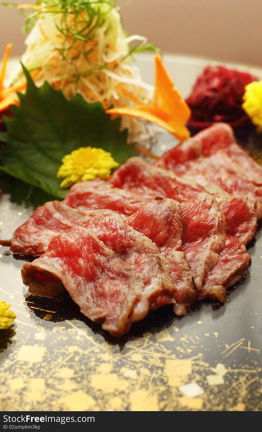 Rare wagyu beef served on black platter