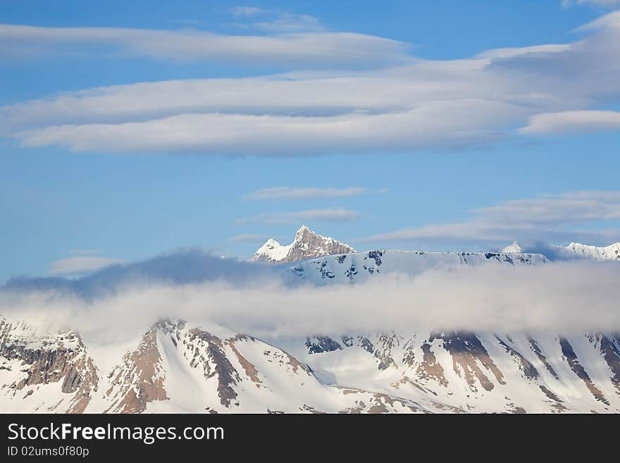 Mountain landscape - high mountains in clouds