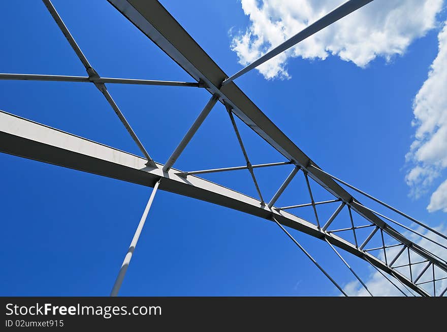 Elements of modern tied arch bridge on picturesque cloudy sky. Elements of modern tied arch bridge on picturesque cloudy sky