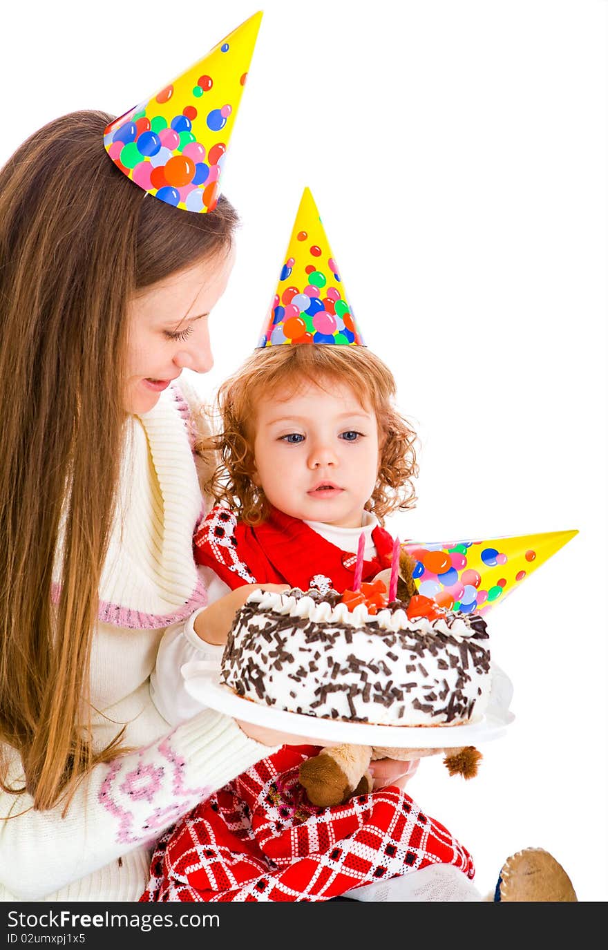 Little girl looking at her birthday cake