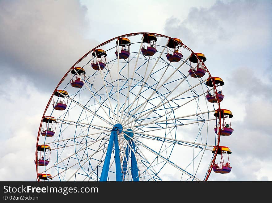 Ferris wheel on the blue sky background