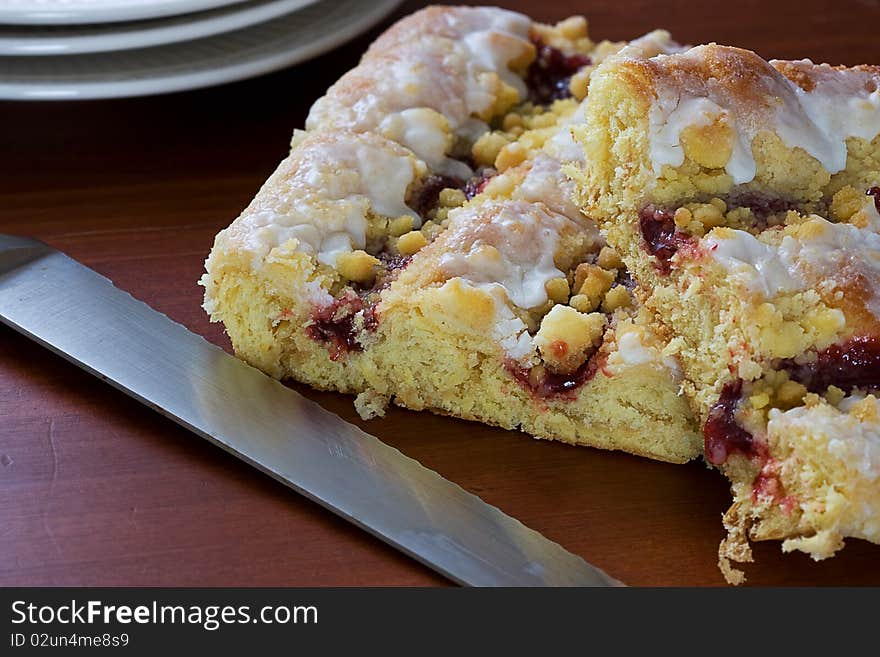 Fruit Danish being cut and served for breakfast. Fruit Danish being cut and served for breakfast.