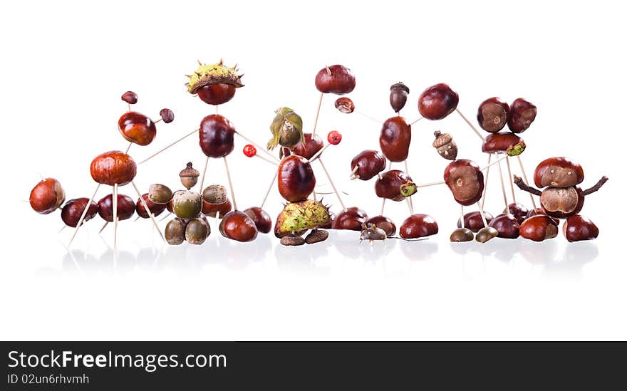 Group of little manikin made of chestnuts isolated on white. Group of little manikin made of chestnuts isolated on white