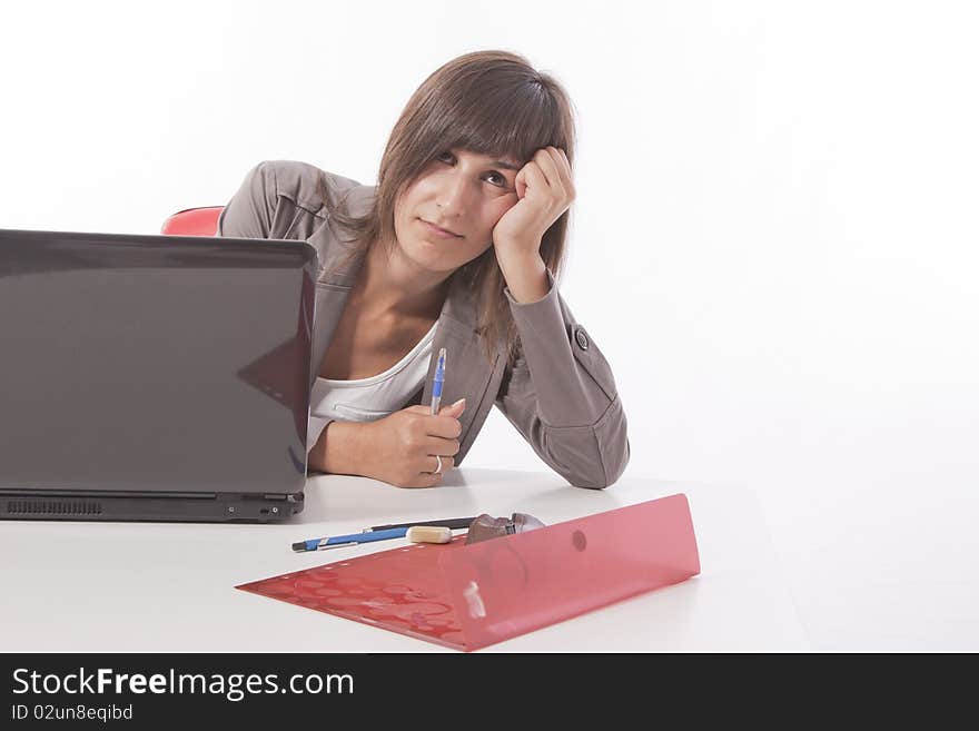 This photo shows a borred woman at work thinking on vacacions. This photo shows a borred woman at work thinking on vacacions.