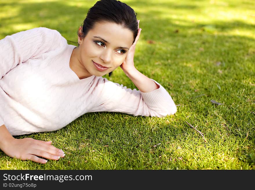 Pretty young woman laying in the grass. Pretty young woman laying in the grass