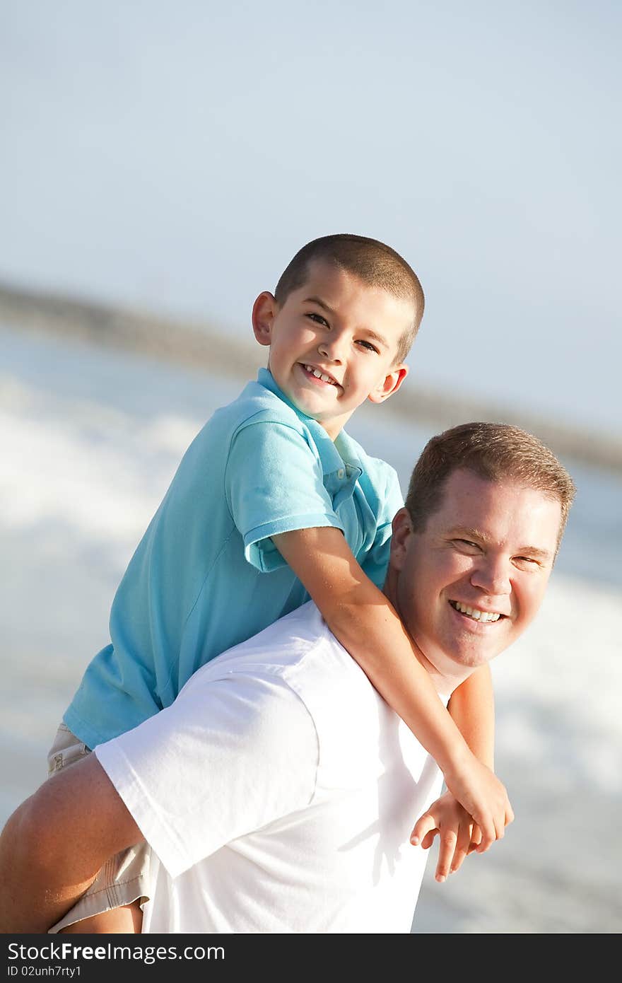 Father and son playing on the beach