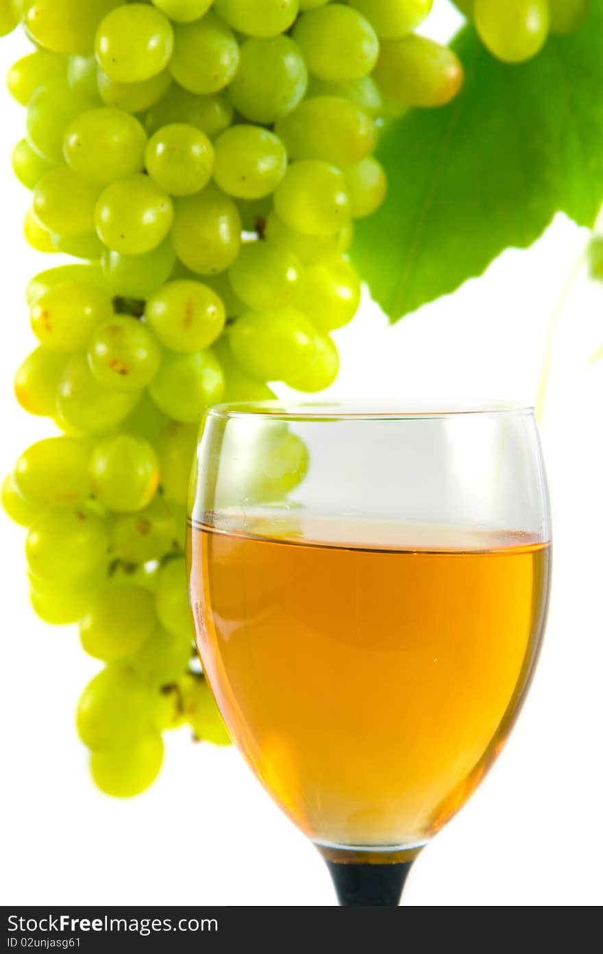 Glass of wine and grapes on a white background